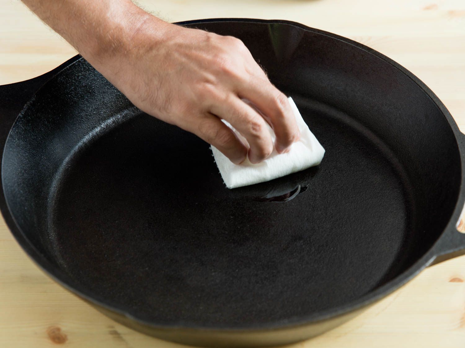 why is my cast iron smoking when seasoning
